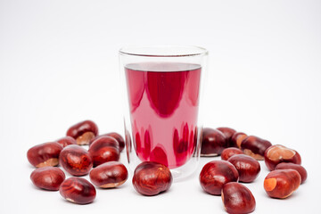 A glass of red liquid is poured into a glass