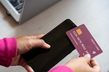 hands holding cell phones and credit cards, the concept of online transactions