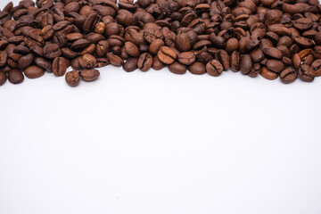 Pile of coffee beans on a white background