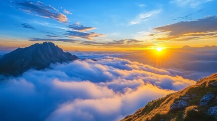 Obraz premium Spectacular sunrise over mangart peak with dramatic views of alpine mountains above the clouds in slovenia, capturing the majestic beauty of a rugged mountain landscape and tranquil dawn colors in a s