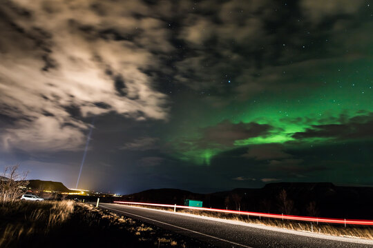 iceland sky over reykjavik, imagine peace tower light and aurora borealis, real photo, column of light, videy, kollafjordur, aurora, borealis, clouds