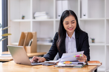 Business asian woman Reviewing Documents, business woman's hands meticulously reviewing a stack of...