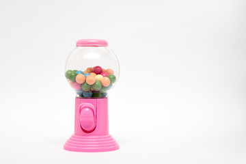 Pink gumball machine with a clear glass container full of colorful gumballs