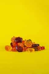 Assorted gummy candies, Juicy colorful jelly sweets. Gummy candies on yellow background
