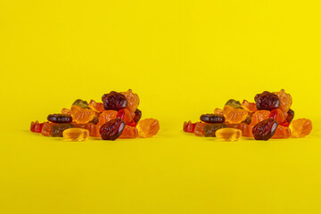 Assorted gummy candies, Juicy colorful jelly sweets. Gummy candies on yellow background