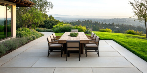 Modern outdoor dining area with a stunning view of the hills at sunset