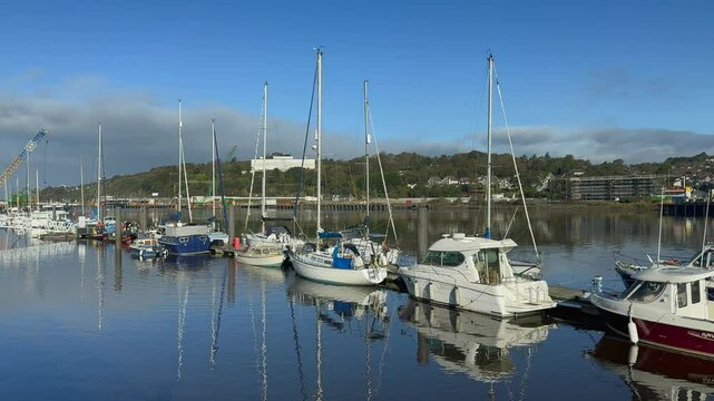 Private boats moored at marina dock on River Suir in Waterford, IRL