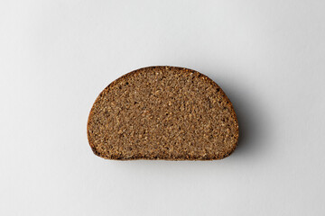 Sliced Dark Rye Bread Loaf Showing Textured Crumb on white background