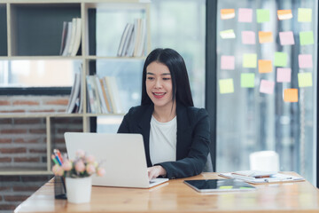 Confident Businesswoman Working on Laptop in Modern Office 