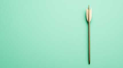 A minimalist image of a single arrow on a mint green background, perfect for representing focus and direction.