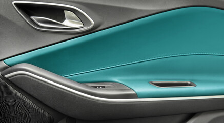 Naklejka premium Door handle with Power window control buttons of a luxury passenger car. Blue leather interior of the luxury modern car. Modern car interior details