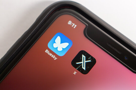 Mexico City, MEXICO - Oct 22 2024 : Bluesky Social and X app are displayed in an iPhone screen.