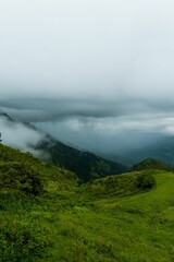 Lush green hills with cloudy sky