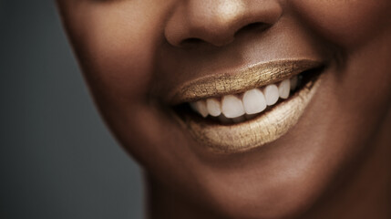 Fototapeta premium Lipstick, gold and mouth of happy woman in studio for beauty, glitter products and cosmetics. Smile, luxury spa and face closeup of model on dark background for skincare art, makeup glow and shine