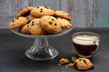 A glass of coffee and a plate of cookies