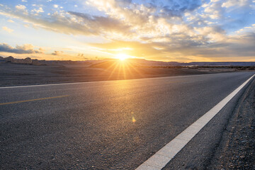 Asphalt highway road and desert with sky clouds natural landscape at sunset. road trip.