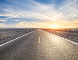 Straight highway road and endless desert nature landscape at sunset. road trip.