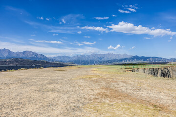 Dirt gravel road square and mountain natural landscape under blue sky. car background.
