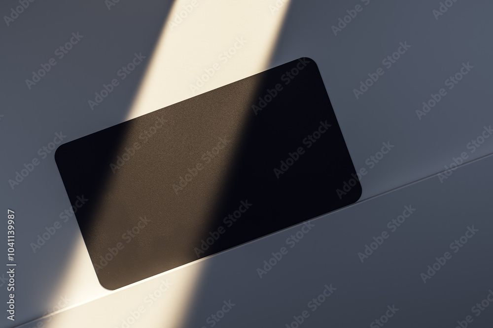 Poster Close up and top view of empty black business card on light desk surface with sunlight. Ad concept. Mock up, 3D Rendering.