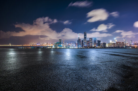 Fototapeta Asphalt road square and city skyline with modern buildings scenery at night in Shenzhen. car advertising background.