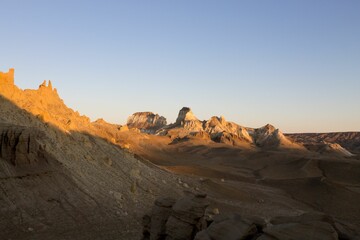 Desert landscape with rocky formations at sunset