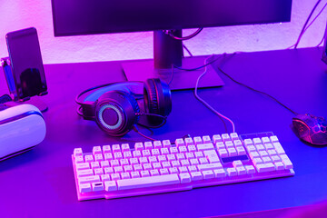 Close up gamer work space gaming set up modern equipment on desk, gaming gear, mouse, headset, computer mouse ready for online streaming © sorapop