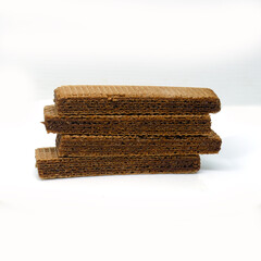 Chocolate wafer biscuits stacked on top of each other on a white background