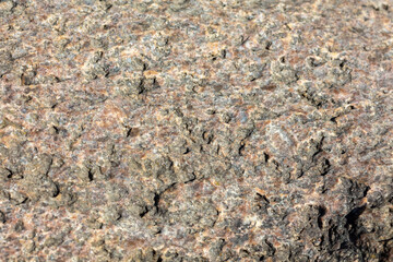 Close-up of textured rough granite rock surface, detailed natural stone pattern, abstract background for geology and nature themes, high-resolution texture study, mining, construction materials