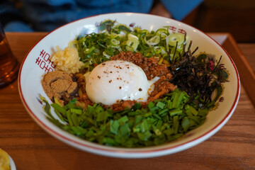 Japanese food mixed with vegetables, eggs, and a generous sauce