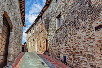 The narrow alleyways of Collemancio reveal beautifully preserved medieval architecture set against...