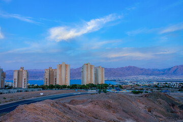 Fototapeta premium modern city in desert near sea Middle East region twilight low lighting country side landmark landscape environment space