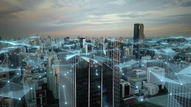 Aerial cityscape at sunset of modern smart city with internet web connection animation above skyline skyscraper building