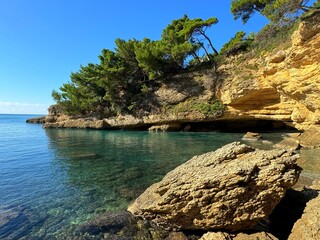Scenic sea cove clear emerald blue water, rocks and stones beautiful landscape