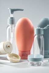 Variety of travel-sized containers displayed against a bright blue background