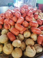 Fried sausages and fish balls, a street food in Thailand, are usually eaten with a sweet and spicy dipping sauce.