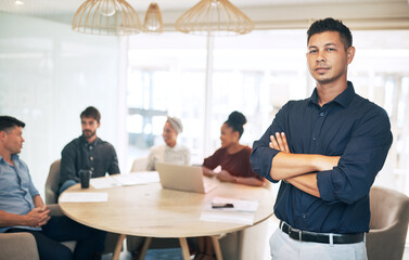 Business, man and portrait with arms crossed in meeting for financial workshop and investment planning. Professional, employees or leader with diversity group in boardroom for company budget strategy