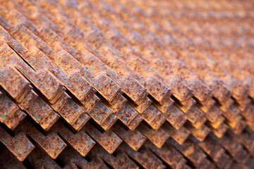 Perforated rusty metal floor sheet stamping plates texture closeup angled view. Metal stamping sheet metal manufacturing lightweight bearing flooring elements structural combine strength functionality