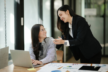 Asian business woman working and talking at the office

