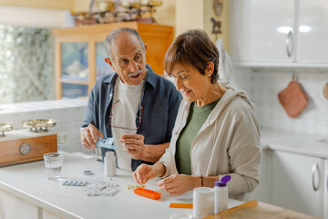 An elderly couple engages in a thoughtful discussion about medication management within a cozy kitchen setting, standing in casual clothing. Organizing pill box, daily routine at home. Horizontal