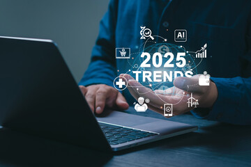 2025 Trends concept. Businessman working on laptop and holding 