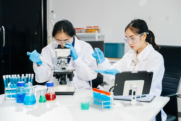 Asian Female Scientists Conducting Chemistry Research in Laboratory