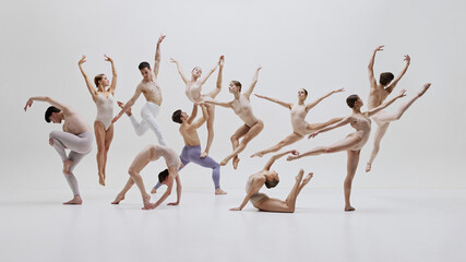 Ballet ensemble captured in perfect synchronization during performance. Graceful movements and...
