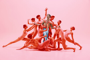 Graceful dance ensemble in synchronized movement. Group of young ballet dancers performing in pink...