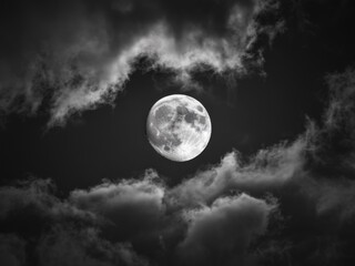 Full Moon Illuminating the Night Sky Amidst Scattered Clouds