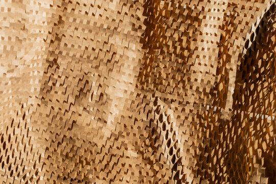 Close-up texture of brown honeycomb cardboard represents eco-friendly packaging solutions and sustainable practices in environmental conservation