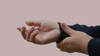 Person adjusting a sweater cuff, neutral background.