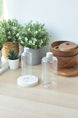 Several plastic bottles with aluminum caps of different sizes, decorated with green plant pots