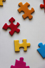 Obraz premium Colorful jigsaw puzzle pieces on white background. Flat lay.