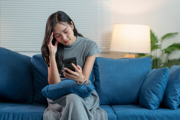 Obraz premium A woman is sitting on the floor in the living room. She is depressed, stressed, worried and in distress for life. Problems from work concept of living, state of mind.