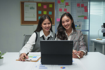 .Teamwork process. Two business women calculating a valuation in the workplace. laptop on the table, typing keyboard, analysis of earnings, analyzing graph plans